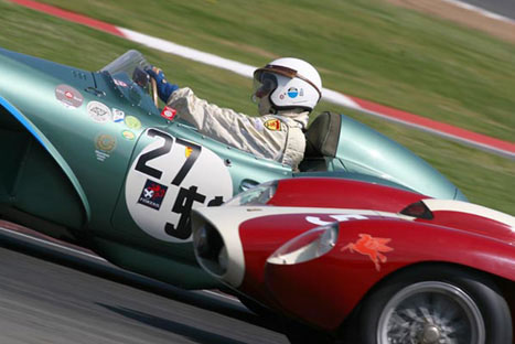 Two cars jostle for position at high speed.